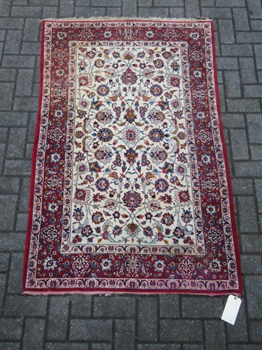 Lot 837 - A silk Isfahan rug with a red and cream ground...