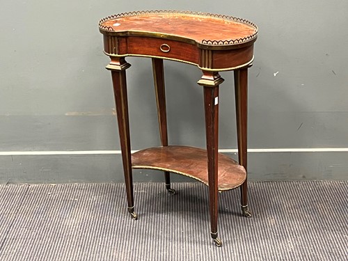 Lot 491 - A French kidney shaped mahogany and brass...