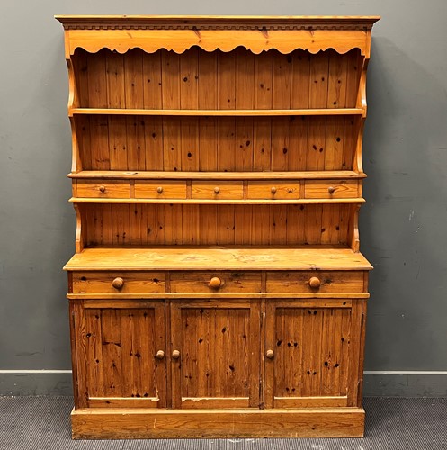 Lot 414 - A 20th century pine dresser with shelf back,...