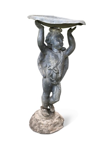 Lot 770 - A small lead model garden cherub