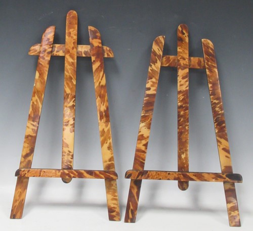 Lot 85 - A near pair of faux tortoiseshell table easels...