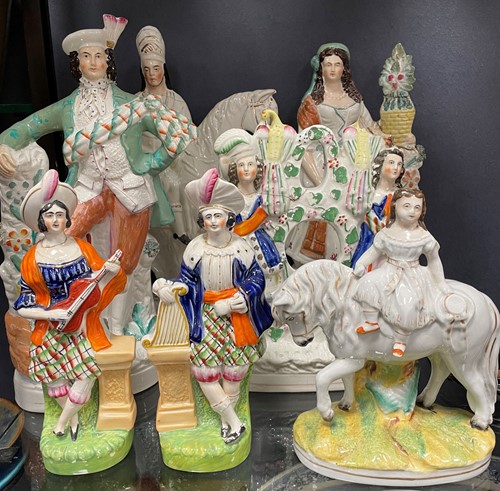 Lot 103 - A collection of Staffordshire figures, most...