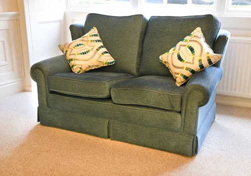 Lot 568 - A modern compact two seater sofa