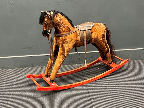 Lot 413 - A small plush covered rocking horse 77 x 106 x...
