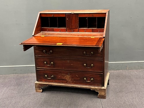 Lot 440 - A George III mahogany slope front bureau....