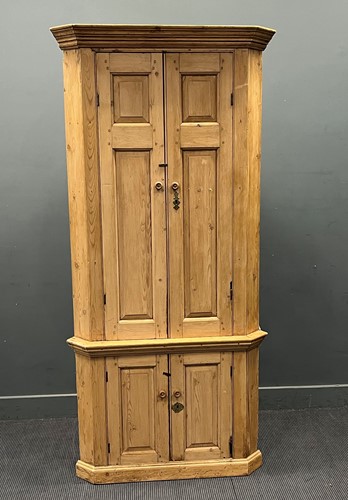 Lot 552 - A George III style pine cupboard with fielded...