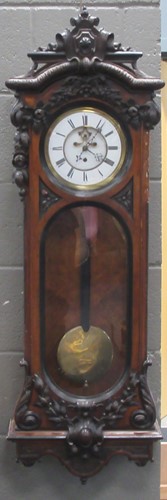 Lot 196 - A walnut Vienna wall clock, with carved swag...