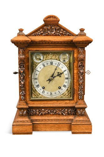 Lot 355 - An Edwardian oak table clock