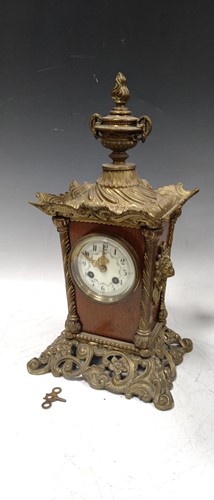 Lot 245 - A decorative brass cased table clock, with urn...