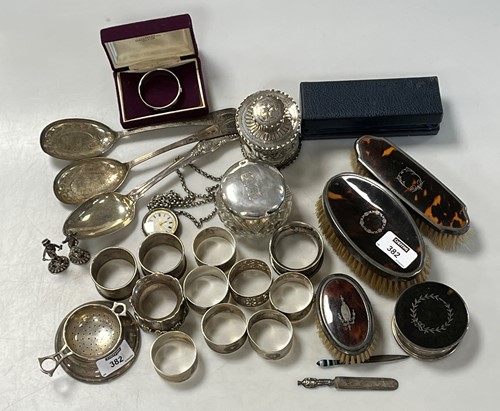 Lot 382 - A collection of silverware including napkin...