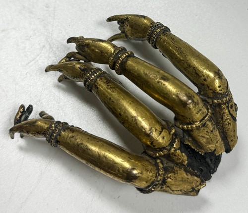 Lot 54 - A Sino-Tibetan gilt bronze multi-armed Buddha limb fragment, 17th/18th century