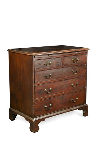 Lot 522 - A George III chest of drawers with brushing slide