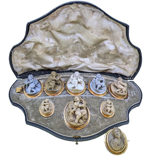 Lot 59 - A 19th century lava cameo suite plus one other brooch