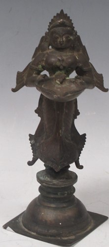 Lot 55 - An early 20th century bronze deity, Indian. 20....