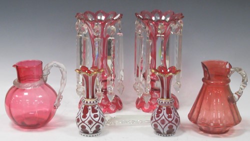 Lot 95 - A pair of Victorian cranberry glass lustres...