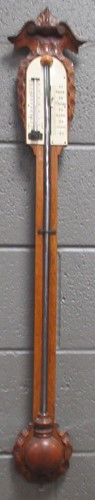 Lot 181 - A late 19th century carved oak stick barometer....