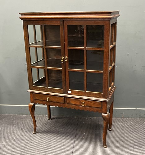 Lot 367 - An Edwardian oak glazed cabinet on associated...