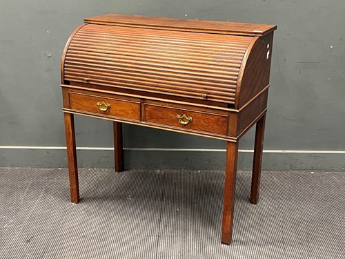 Lot 555 - A George III roll top bureau with two short...