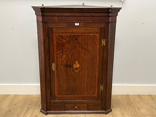 Lot 537 - A large George III oak corner cupboard with...