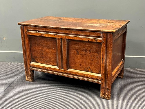 Lot 555 - An oak two plank top blanket box with chip...
