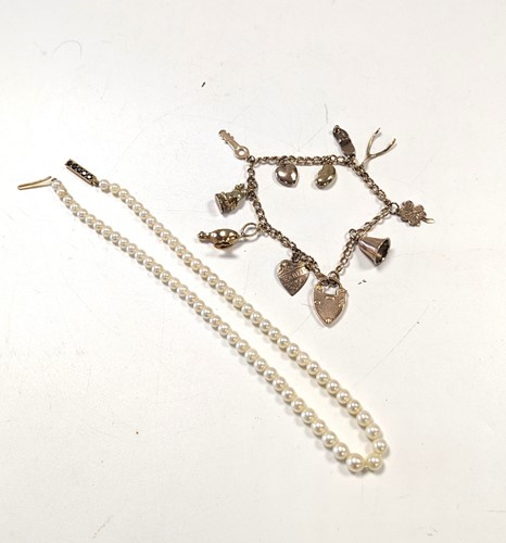 Lot 196 - A charm bracelet, tested as 18ct gold with a...