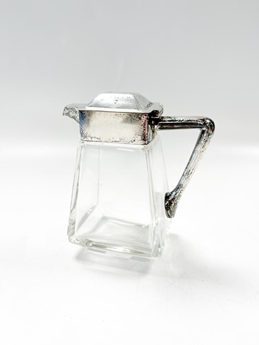 Lot 235 - A small silver rmounted glass jug and a silver...