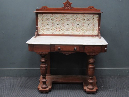 Lot 579 - A Victorian walnut marble topped washstand...