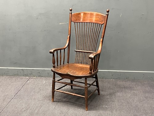 Lot 487 - An Arts & Crafts oak stick back armchair, the...
