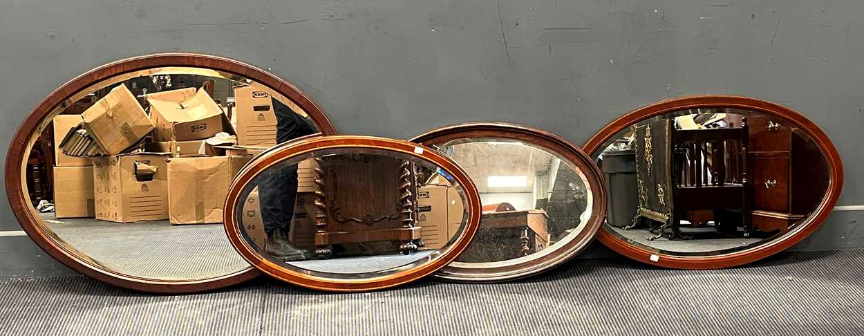 Lot 373 - Four oval wall mirrors, to include two...