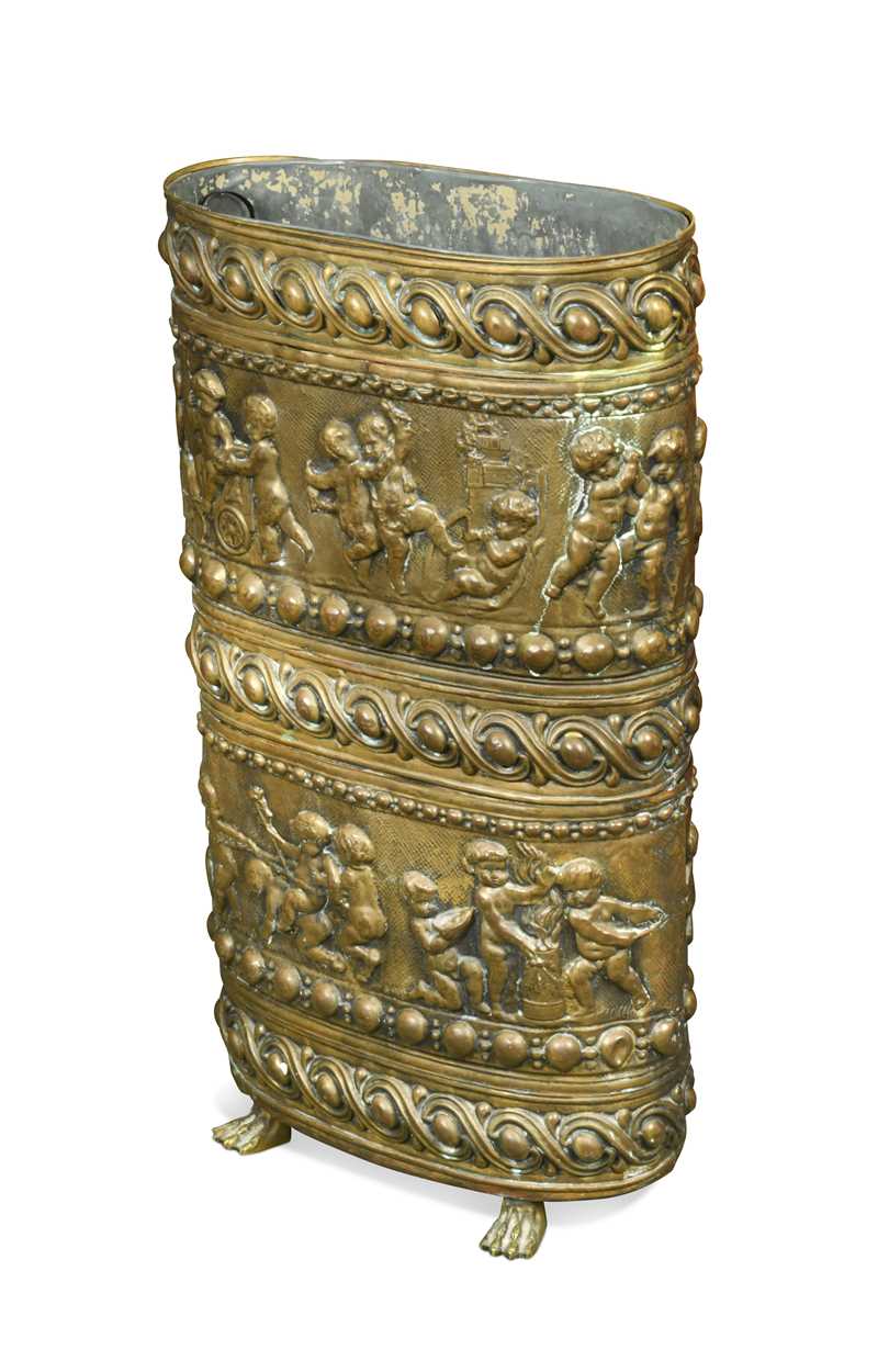 Lot 471 - A brass oval repousse stick stand, late 19th