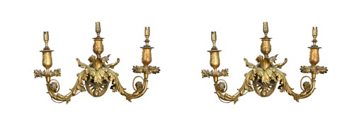 Lot 773 - A pair of gilt metal three branch wall lights, late 19th century