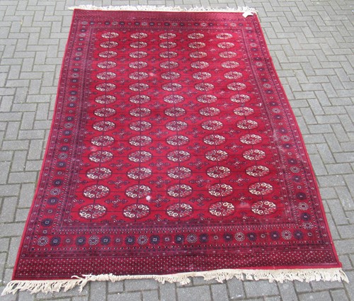 Lot 611 - A Bokhara red ground wool rug 301 x 200cm