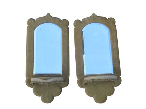 Lot 649 - A pair of pale green velvet covered mirrored...