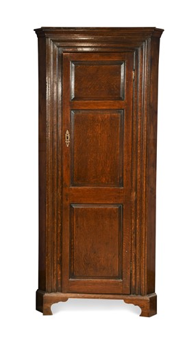 Lot 5 - A George III oak corner cupboard