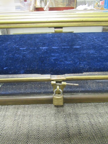 Lot 179 - A brass framed bevelled glass display case,...