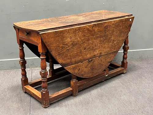 Lot 460 - An 18th century oak gateleg table, with drawer,...