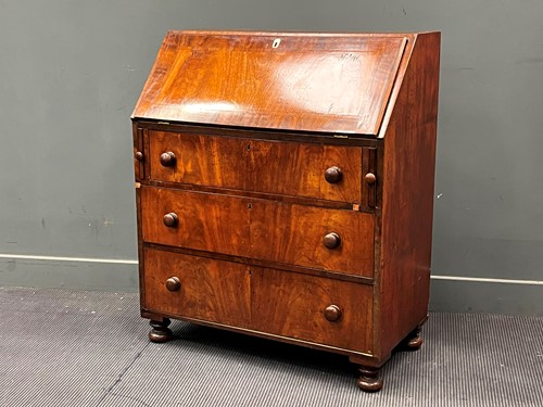 Lot 415 - A 19th century mahogany bureau the fall front...