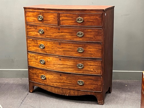 Lot 458 - A Regency mahogany bow front chest of two...