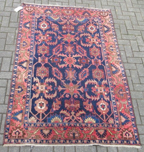 Lot 618 - A Persian blue ground wool rug with red floral...