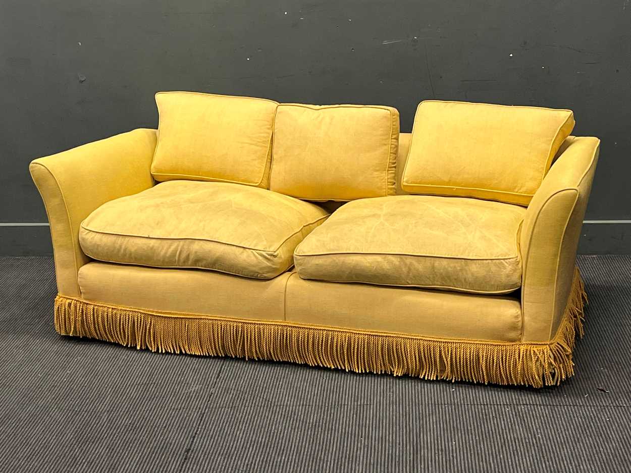 Lot 634 - A yellow sofa with fringe