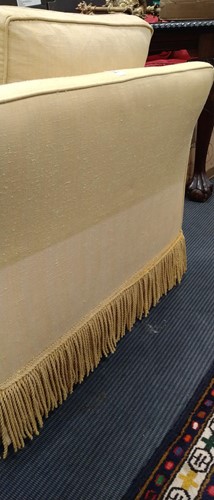 Lot 634 - A yellow sofa with fringe