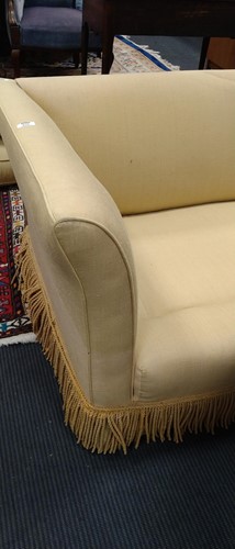 Lot 634 - A yellow sofa with fringe