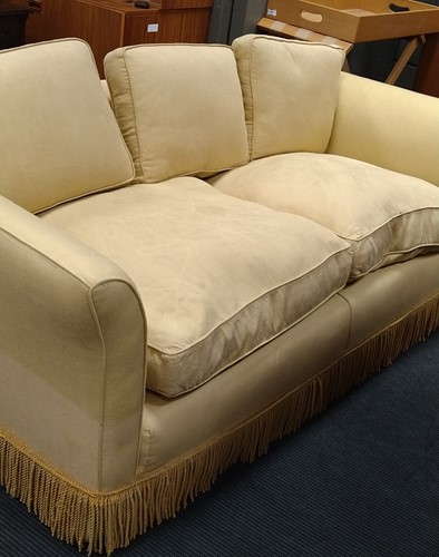 Lot 634 - A yellow sofa with fringe