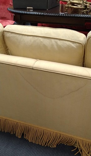 Lot 634 - A yellow sofa with fringe