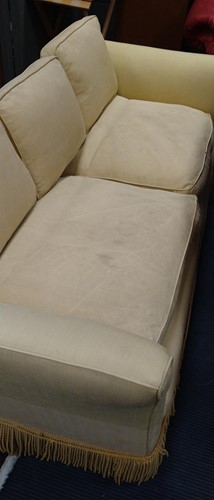 Lot 634 - A yellow sofa with fringe