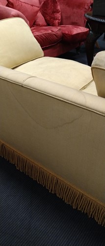 Lot 634 - A yellow sofa with fringe
