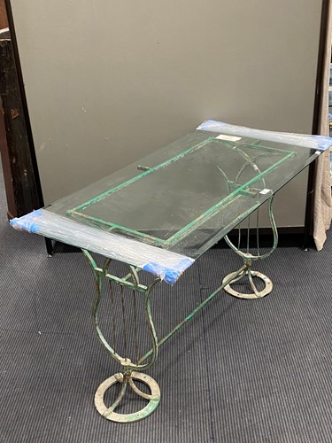 Lot 389 - A green painted metal frame table with glass top