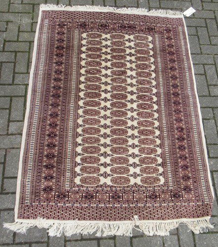 Lot 495 - Sand colour ground rug with brown repeating...