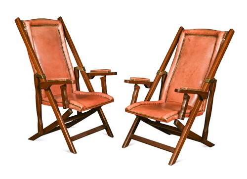 Lot 692 - A pair of folding mahogany lounging armchairs, modern