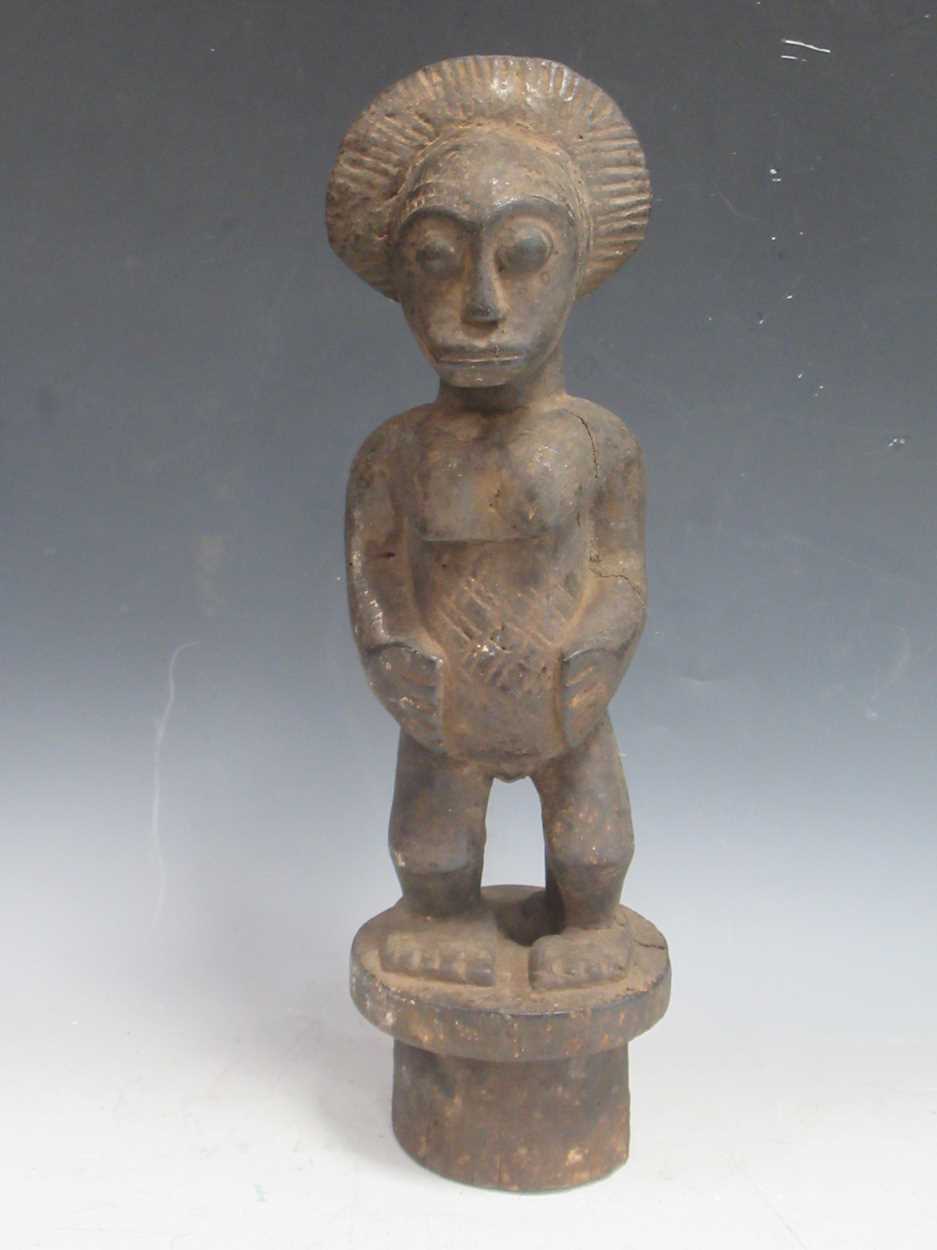 Lot 255 - A West African carved wood figure, probably...